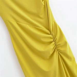 Detailed view of the lemon yellow knitted fabric with elegant ruched pleats and texture