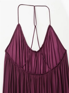 Détail des fines bretelles et du tissu plissé froncé sur une robe violet foncé