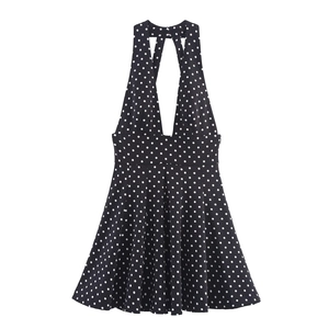 Abito corto nero a pois con scollo all'americana a V profondo e gonna a pieghe a trapezio