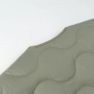 Olive green quilted cotton jacket with wavy stitching pattern and smooth nylon texture