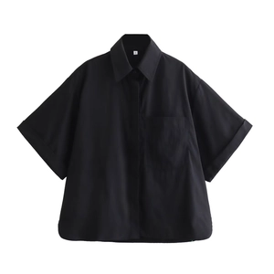 Detail shot of black poplin shirt featuring pointed collar and chest pocket detail