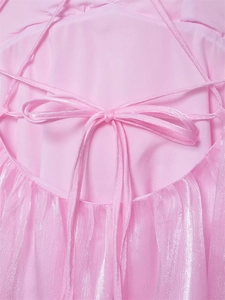 Detail of pink dress featuring a criss-cross lace-up back with a delicate bow tie