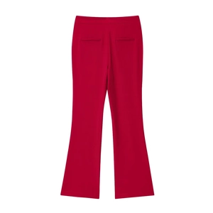 Detail of red high-waisted flared trousers featuring back welt pockets and smooth fabric