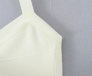 Gros plan détaillé sur la texture en tricot côtelé de la robe licou blanc crème
