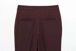 Detailed back view showing tailored welt pockets and seams on dark red trousers