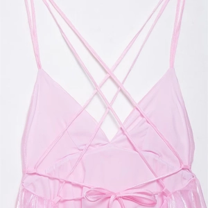 Pink satin mini dress with crisscross back straps and elegant bow detail at the rear