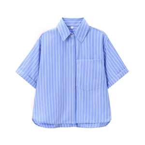 Detail view of the blue and white striped poplin shirt with front pocket and cuffed sleeves