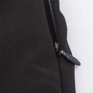 Detailed macro view of invisible teardrop zipper on elegant black summer dress fabric