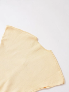Detailed close-up of the round neckline and soft knit texture of this pale yellow sweater