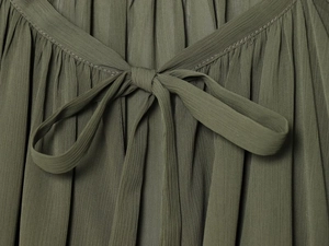 Close-up of olive green chiffon fabric with fine vertical pleats and tie-bow detail