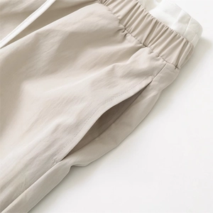 Minimalist beige casual wide-leg pants with elastic drawstring waist and side pockets