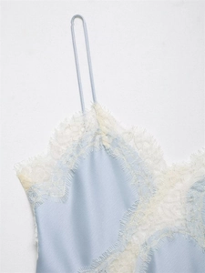 Detailed close-up of light blue satin fabric with white eyelash lace trim and thin strap