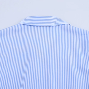 Détail du tissu en coton à fines rayures bleues et blanches et du col de la robe d'été légère