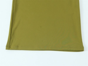 Detail view of the olive green dress hem showing precision double-needle stitching quality