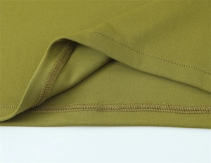 Close-up of olive green knit fabric showing high-quality stitching and seam detailing