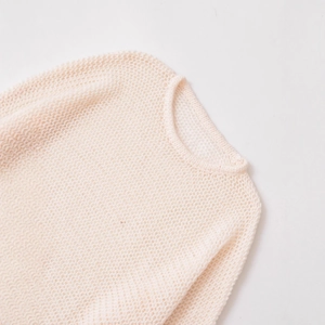 Minimalist loose-fit hollow knit sweater for women in soft beige with honeycomb texture