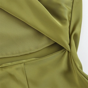 Detailed macro view of olive green satin fabric texture and premium stitching craftsmanship