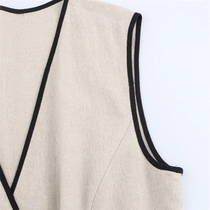 Detail view of cotton linen blend beige sleeveless dress with black piping on the collar