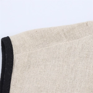 Detailed macro view of the breathable cotton linen fabric with contrast black edge piping