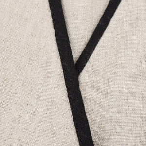 Macro detail of breathable cotton linen fabric with contrast black woven tape trim
