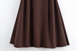 Detailed close-up of the deep coffee brown A-line dress hem with smooth satin finish