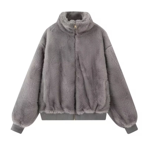 Close-up of grey faux fur jacket showing zipper detail and ribbed cuffs on white background