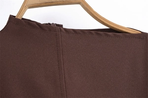 Detailed view of dark brown woven neckline with neat stitching and an invisible zipper