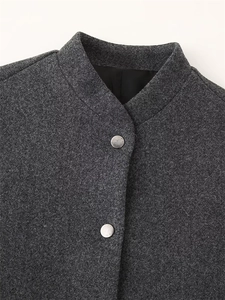 Macro shot of dark grey wool blend jacket with stand-up collar and silver metal buttons