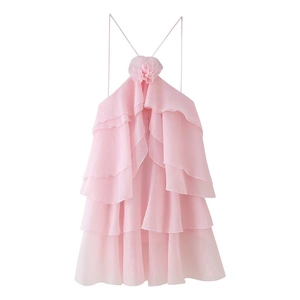 Detail showing the pink halter neck dress with delicate floral ruffles and chiffon layers