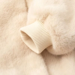 Macro shot of elastic ribbed cuffs on a beige faux fur jacket showing soft texture