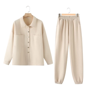 Detail of apricot two-piece suede lounge set featuring buttoned shirt and jogger pants