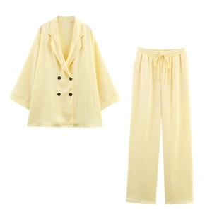 Detail of double-breasted yellow suit with vertical texture and drawstring waist pants