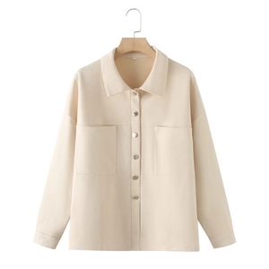 Detail view of beige suede jacket showing front buttons and symmetrical chest pockets