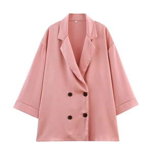 Macro view of pink double-breasted blazer collar with pleated texture and S-size tag