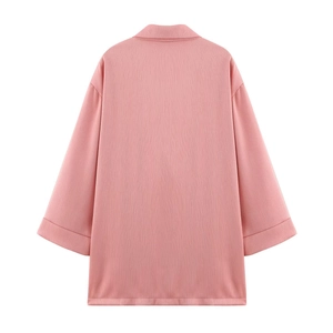 Detail view of pink double-breasted suit jacket back with ribbed fabric texture