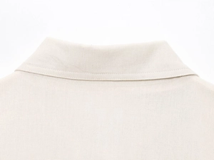 Detailed macro view of high-quality cotton linen fabric and collar stitching on jacket