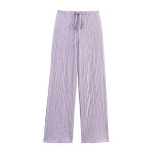 Detail of light purple wide-leg trousers featuring seersucker texture and drawstring waist