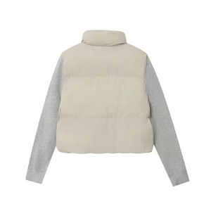 Detail view of the quilted beige jacket with contrasting grey knit sleeves and stand collar