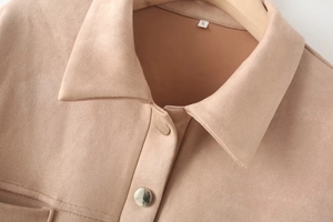 Detailed view of apricot suede jacket featuring lapel collar and silver metal button