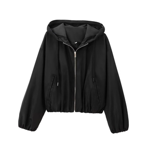 Detail view of black hooded jacket featuring silver metal zipper and elastic cuffs