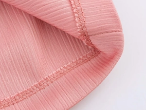 Close-up of pink ribbed fabric texture and high-quality double-needle stitching detail