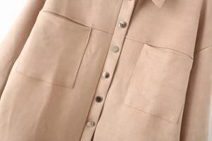 Detailed view of camel faux suede jacket featuring metal buttons and large flap pockets