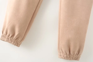 Detailed close-up of elastic cuffs and stitching on khaki faux suede lounge pants