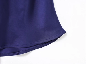 Macro detail of navy blue satin dress showing smooth texture and high-quality hem stitching