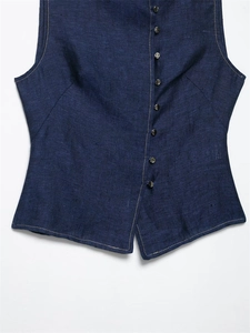 Detail of navy vest featuring contrast yellow stitching and metallic buttons
