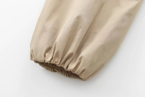 Detailed close-up of khaki jacket cuff with elasticated hem and neat stitching detail