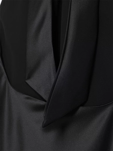Macro view of black dress featuring satin and matte fabric stitching with clean seams