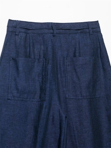 Close-up of navy blue linen trousers showing waist belt loops and back patch pockets