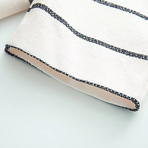 Close-up of black and white striped waffle knit fabric showing fine texture and stitching
