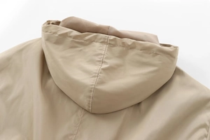 Close-up of light khaki hooded jacket back detail with premium windproof fabric texture